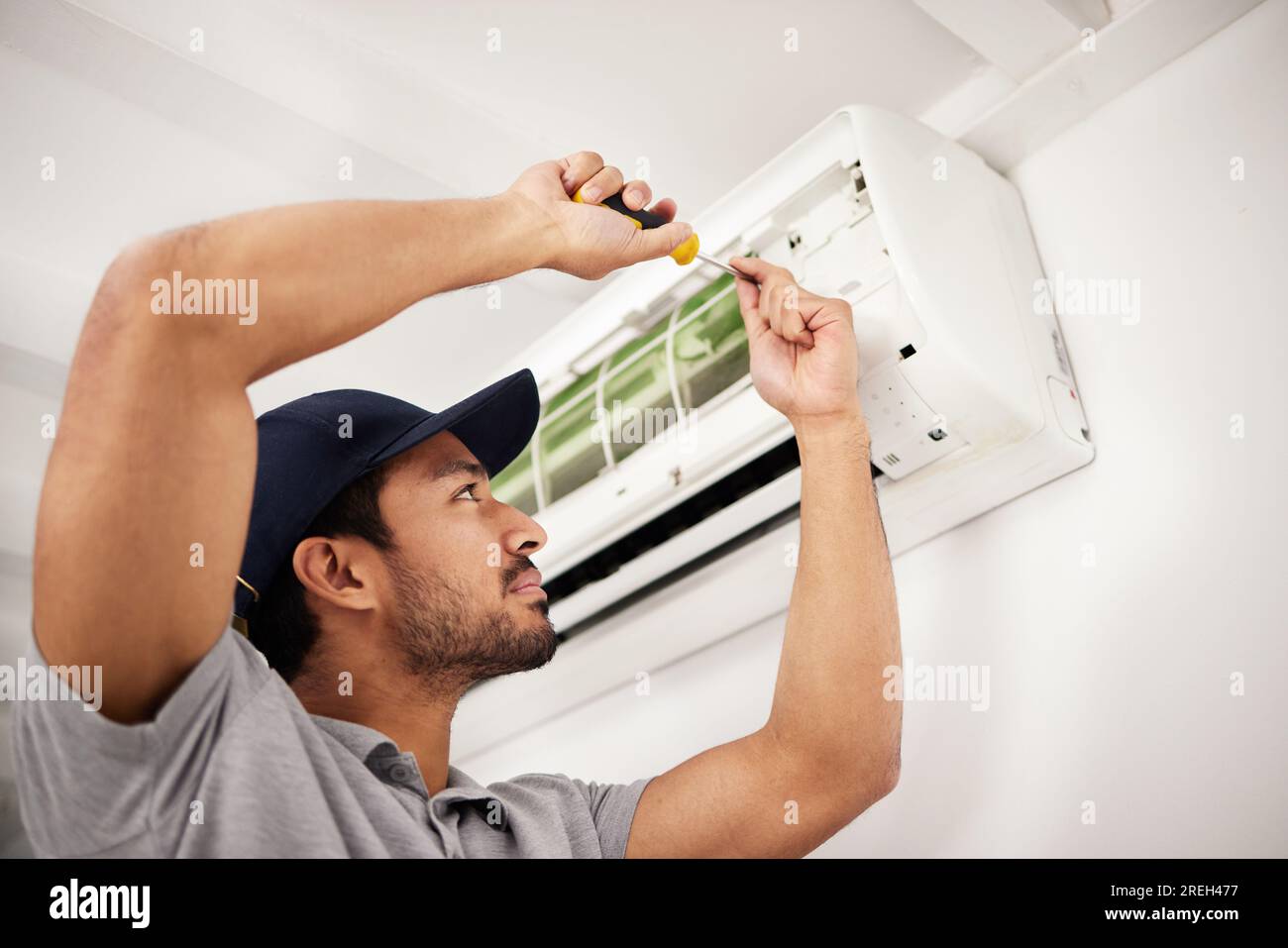 Air conditioner, man and electrical machine repair with person in a home with ac box