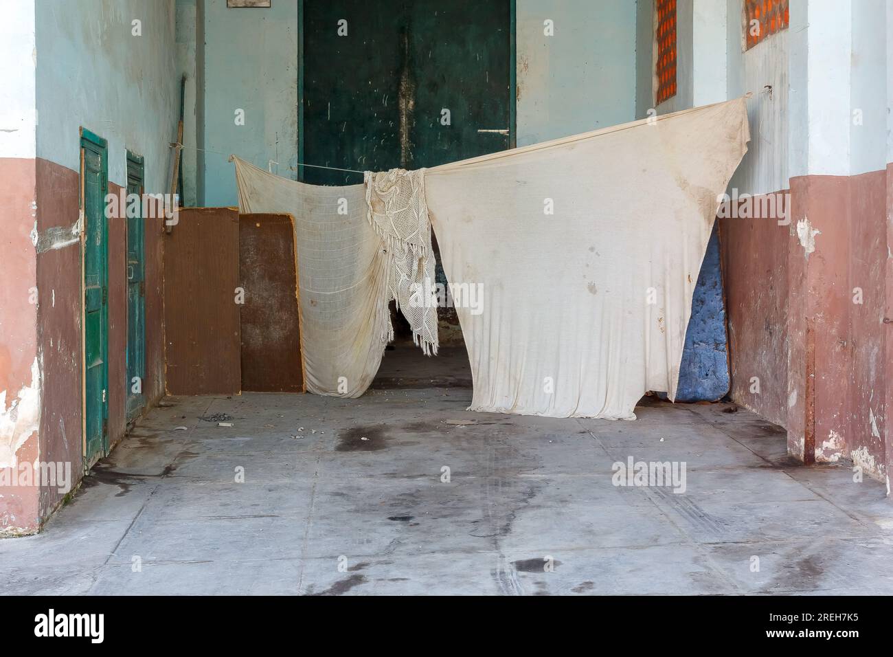Havana, Cuba,  Large white textile pieces drying in a a garage. Stock Photo