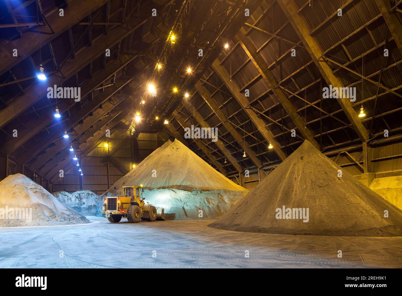 Mechanical shovel arranging copper concentrate stock pile. Stock Photo