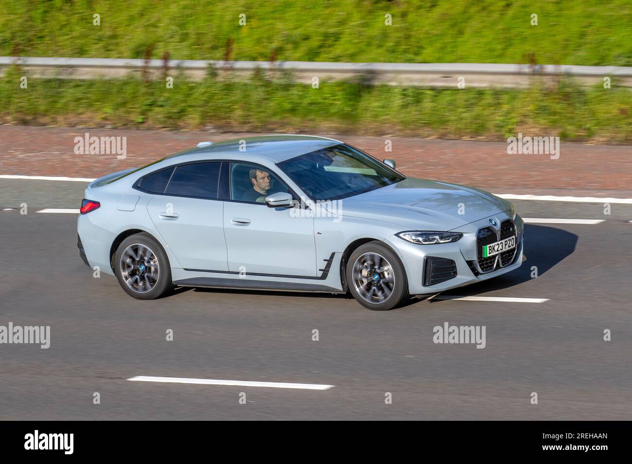 BMW Grey I4 Edrive40 M Sport; travelling at speed on the M6 motorway in Greater Manchester, UK Stock Photo