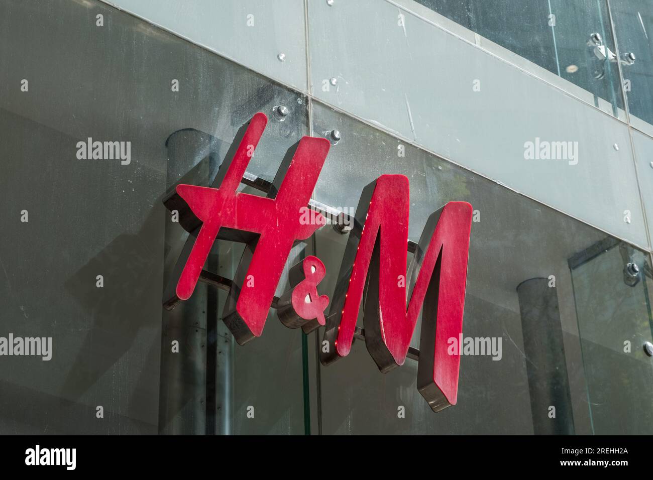 Large red H&M sign and logo outside a shop in New Street, Birmingham, UK Stock Photo