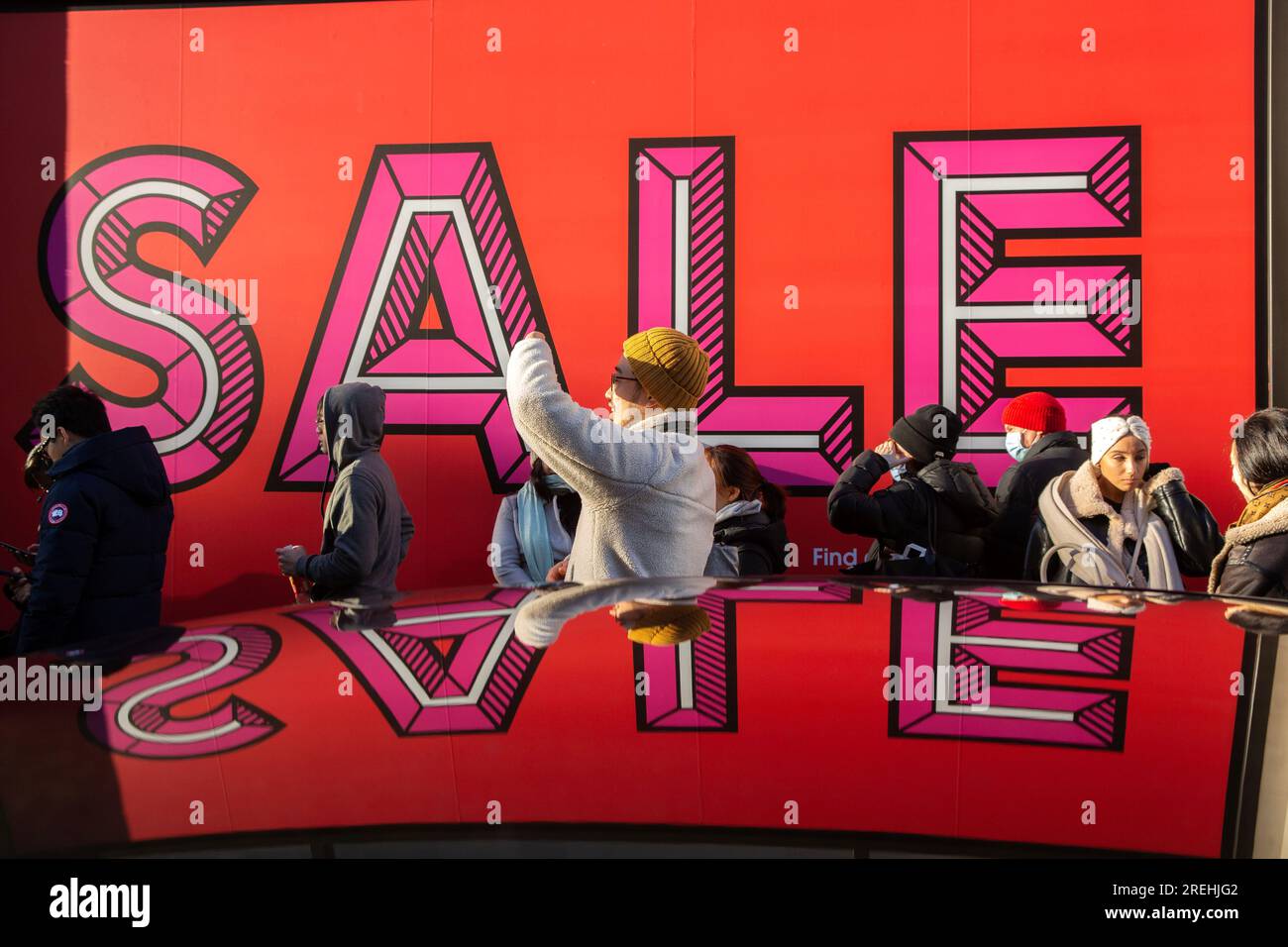 People wait outside Selfridges store on Oxford Street in London, ahead