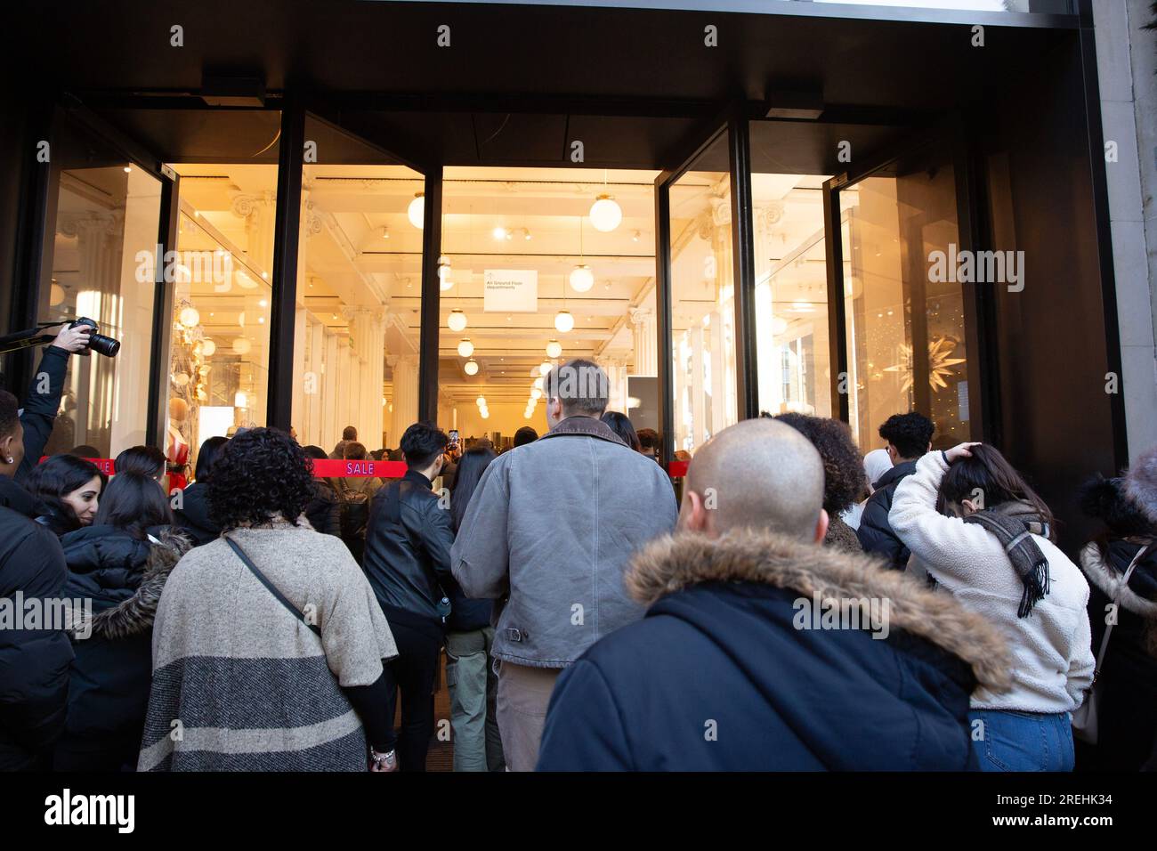 People enter Selfridges store on Oxford Street in London, at the