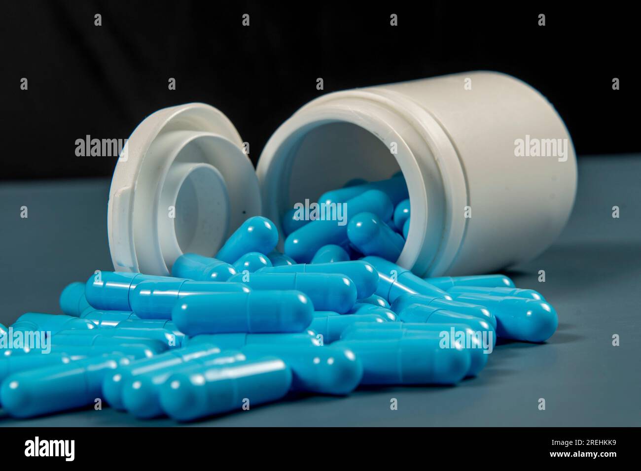 Gelatin pills sticking out of a white medicine bottle. Pharmaceutical