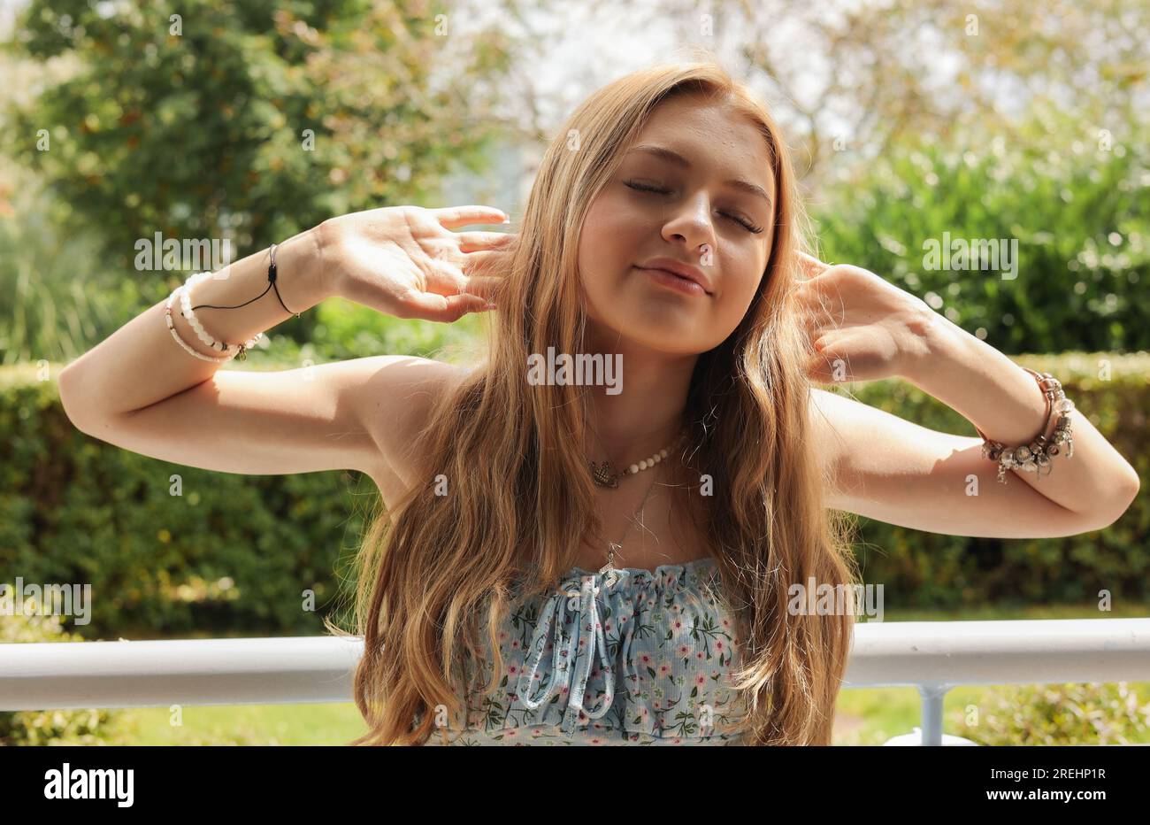 The teenage girl with long blonde hair Stock Photo
