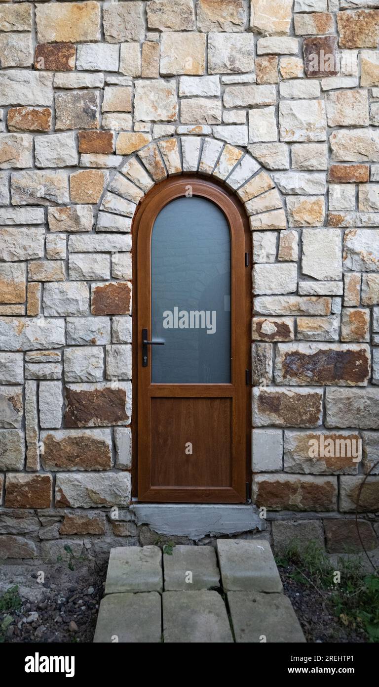 wooden doors in a stone wall Stock Photo - Alamy