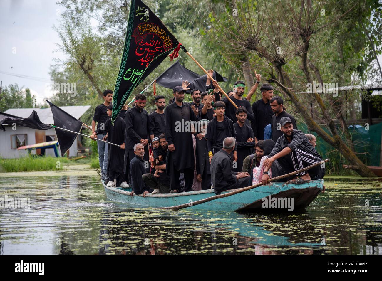 Srinagar, India. 28th July, 2023. Kashmiri Shia Muslims holding flags ...