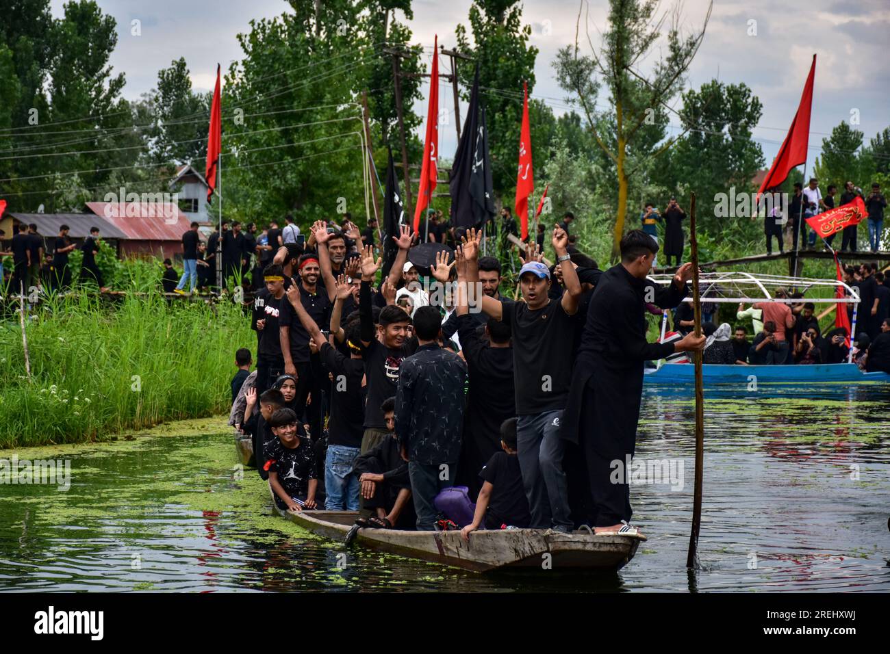 Kashmiri Shiite Muslims shout religious slogans as they participate in ...