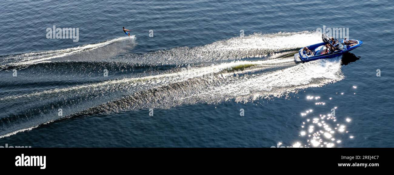 A speedboat pulls a water skier around Middle Range Pond in Poland