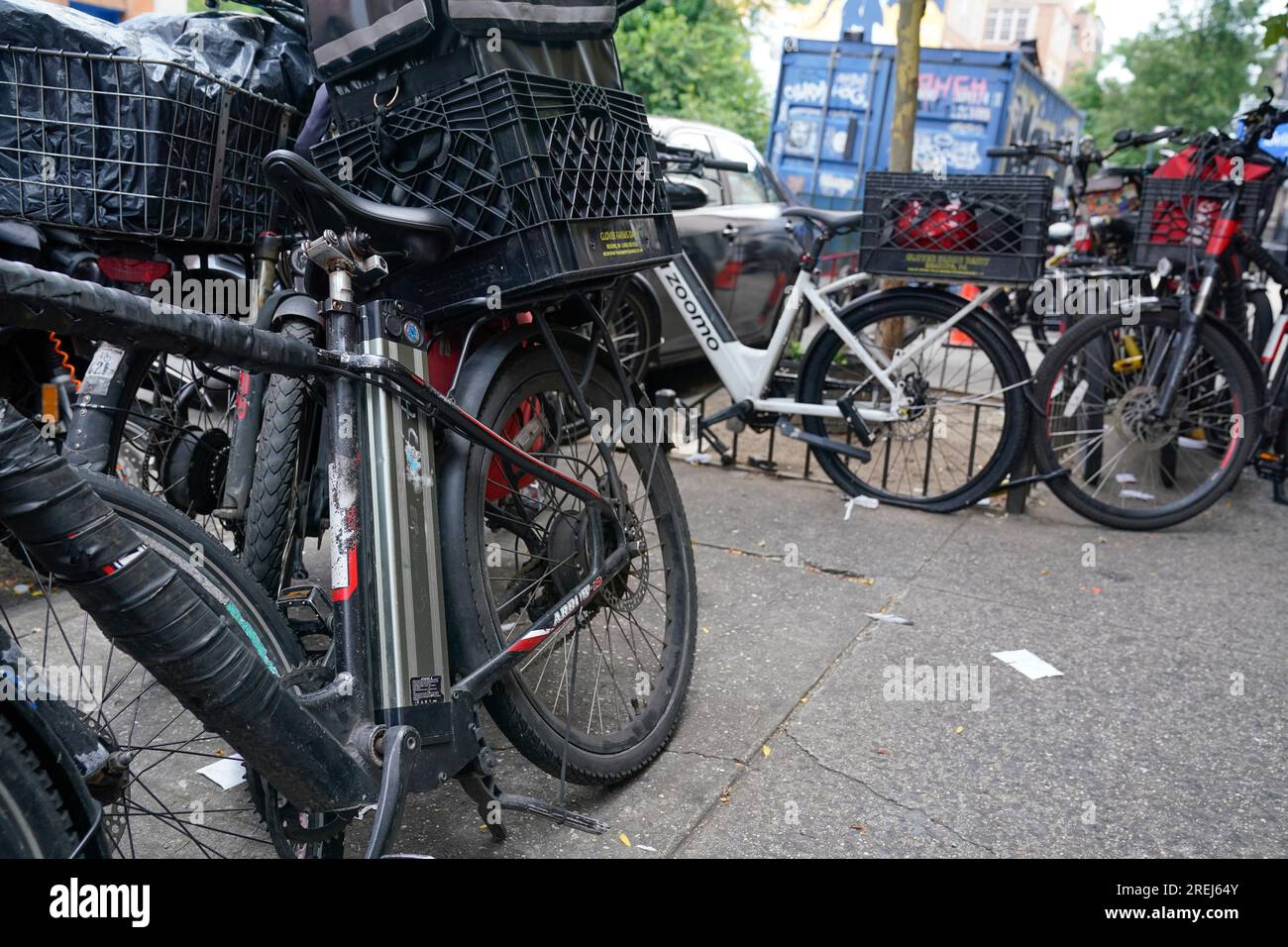 Motorized bicycles are parked while delivery workers take a break in New  York, Tuesday, July 25, 2023. As the coronavirus dug in, the number of  motorized bicycles dashing through New York City