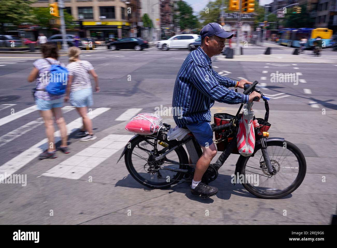 A man rides a motorized bicycle in New York, Tuesday, July 25, 2023. As the  coronavirus dug in, the number of motorized bicycles dashing through New  York City swelled, as cocooning residents