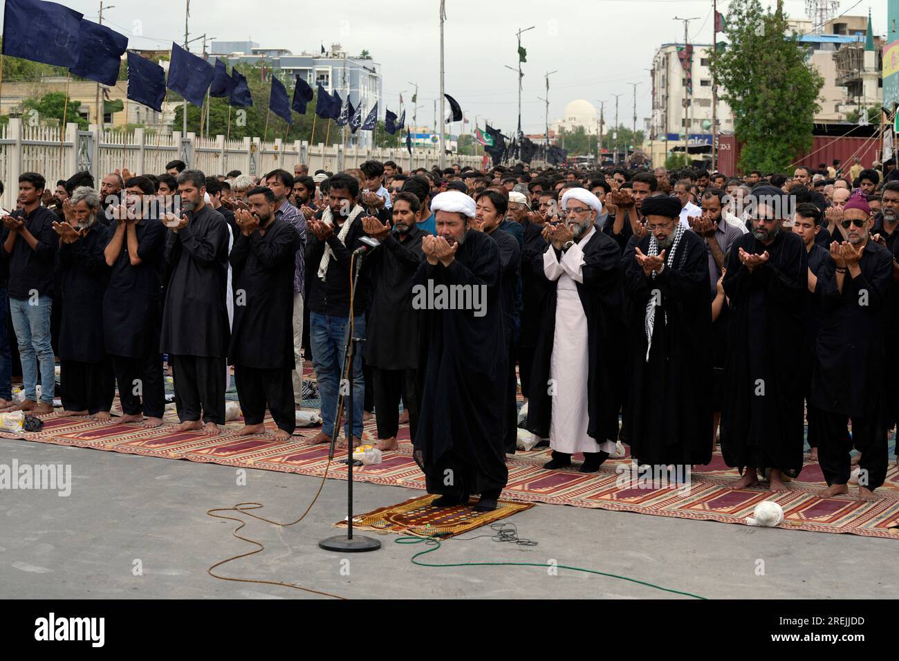 Shiite Muslims pray during a procession to mark Ashoura in Karachi ...