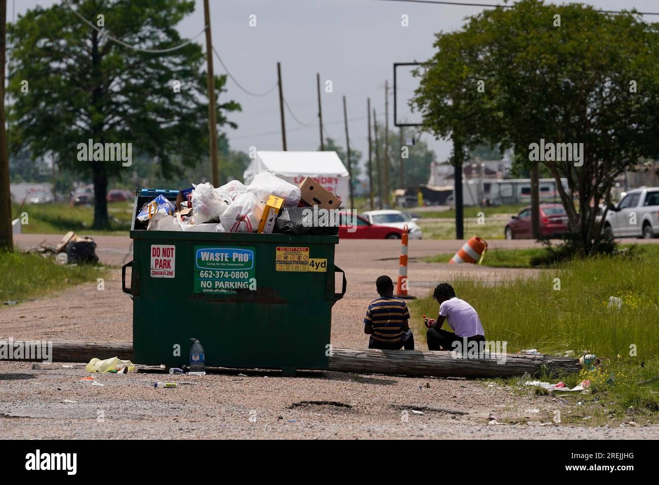 Children sit outside the Rolling Fork Motel, where displaced families