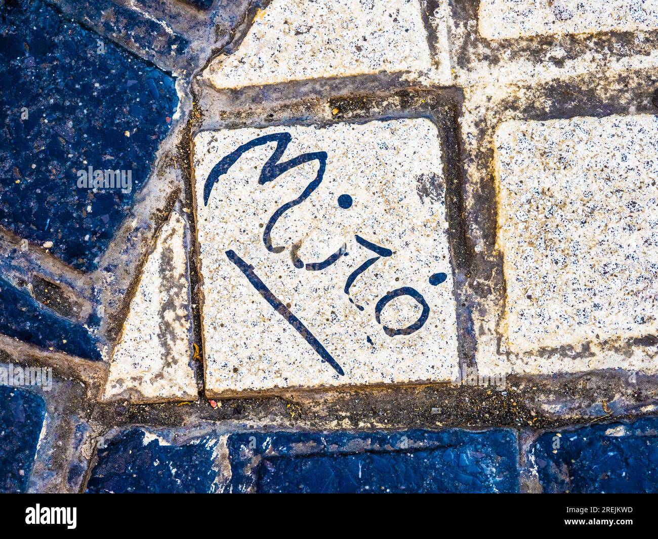 Joan Miró's signature in one of the terrazzo tiles in his pavement mosaic at Plaça Boqueria halfway along Las Ramblas in Barcelona, Catalonia, Spain. Stock Photo