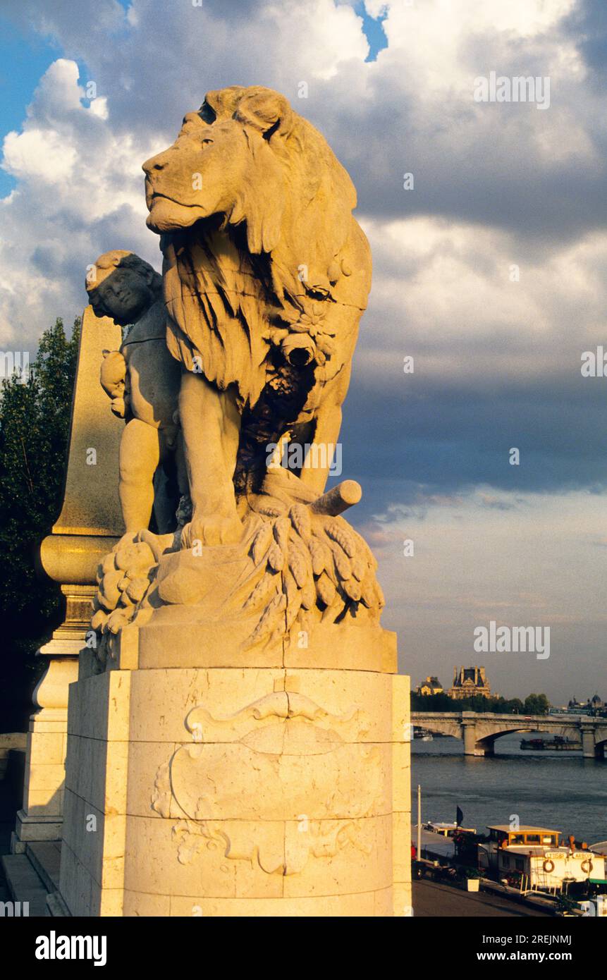 Paris Pont Alexandre III, Lion statue sculpture at sunset. Beaux-Arts style bridge over the River Seine in Paris France Stock Photo