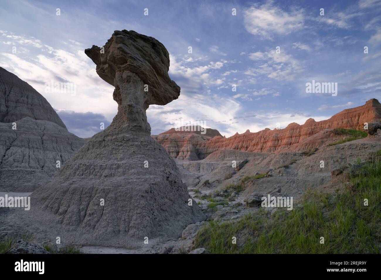 Early morning clouds pass over the large hoodoo known as Toadstool Rock near Norbeck Pass in South Dakota's Badlands National Park. Stock Photo