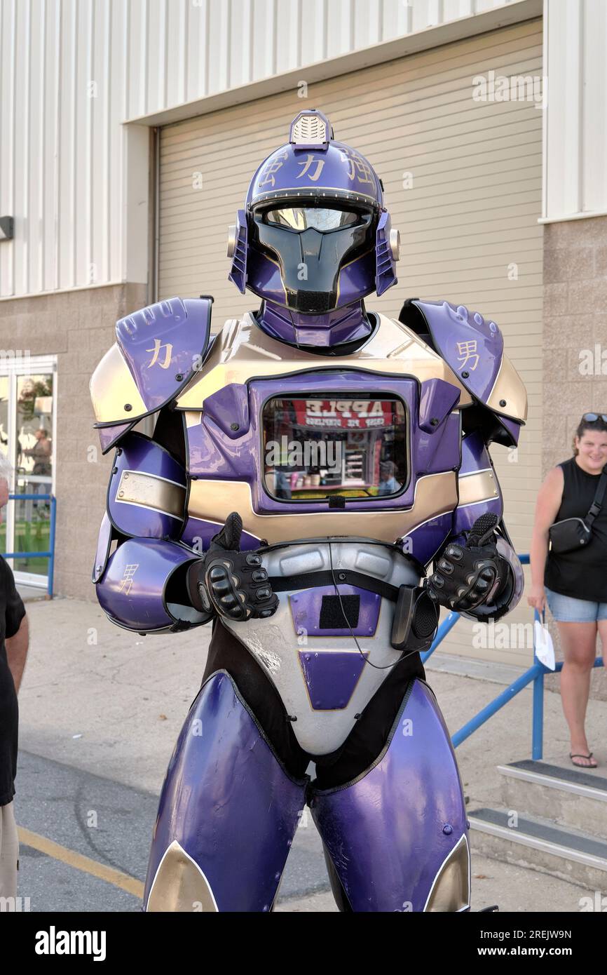 Performer, costumed as a Transformer character, engages with crowds on the midway at the 2023 Delaware State Fair, Harrington, Delaware USA. Stock Photo