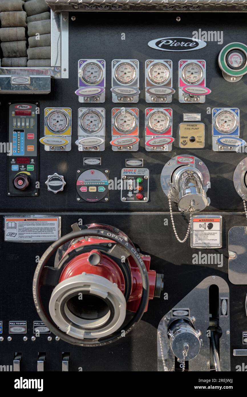 Control board, guages, and valves on a modern fire pumper truck. Stock Photo