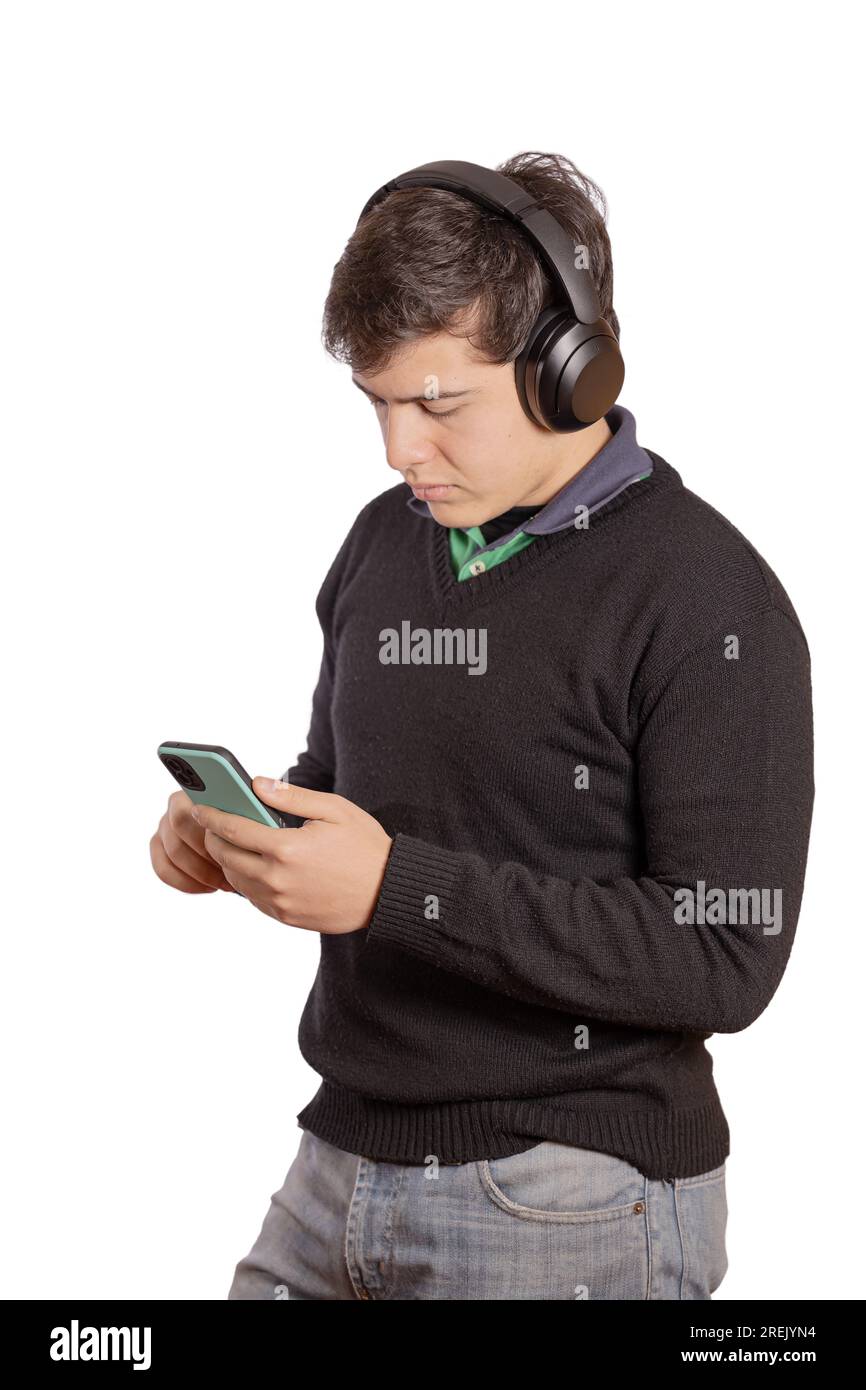 Portrait of a boy with headphones using his mobile phone isolated on white background. Stock Photo
