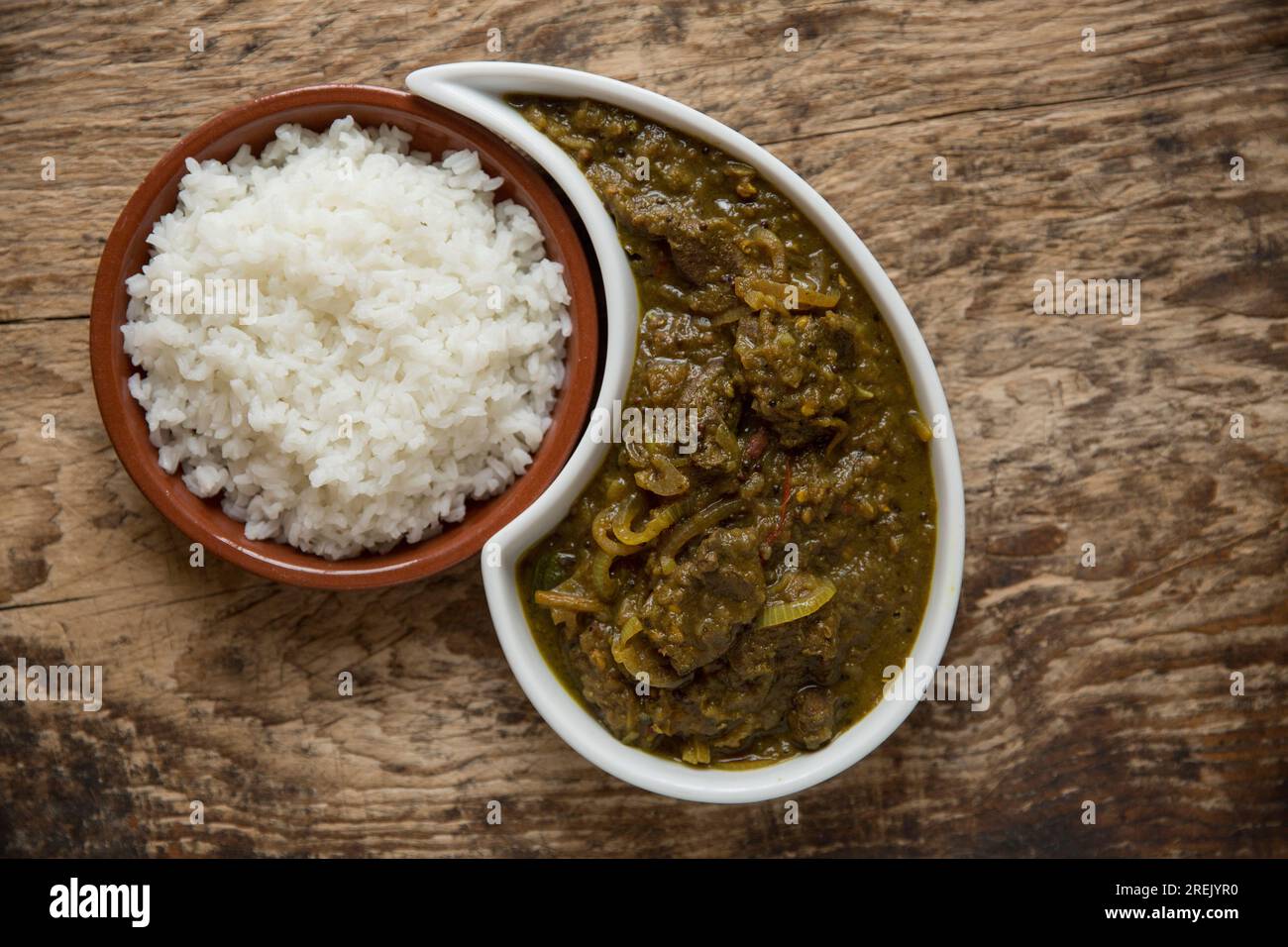 A curry made with woodpigeon fillets served with white rice. Ingredients include onions, garlic and a range of spices. England UK GB Stock Photo