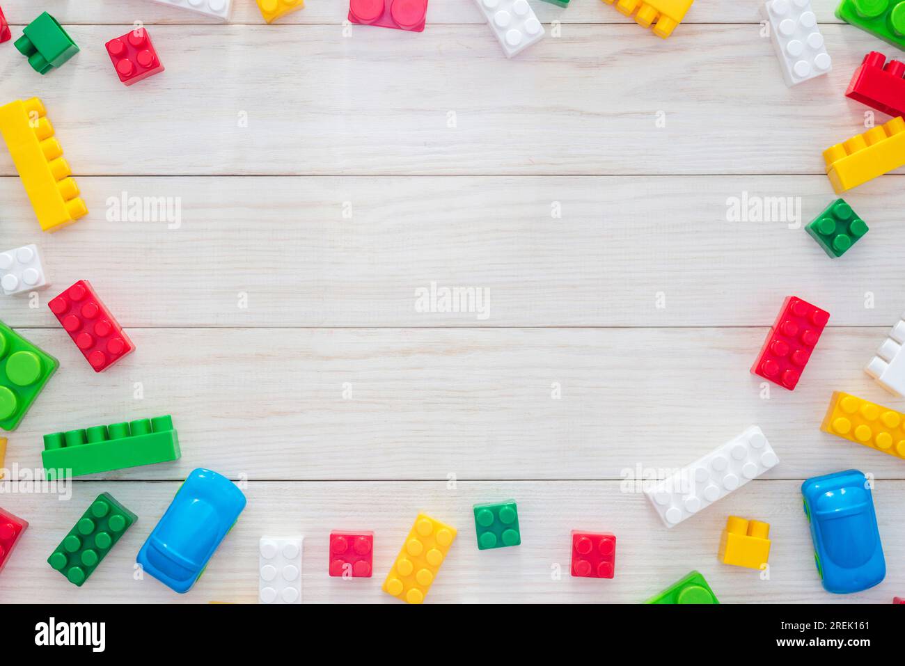 Colorful plastic construction blocks on white wooden background Stock ...