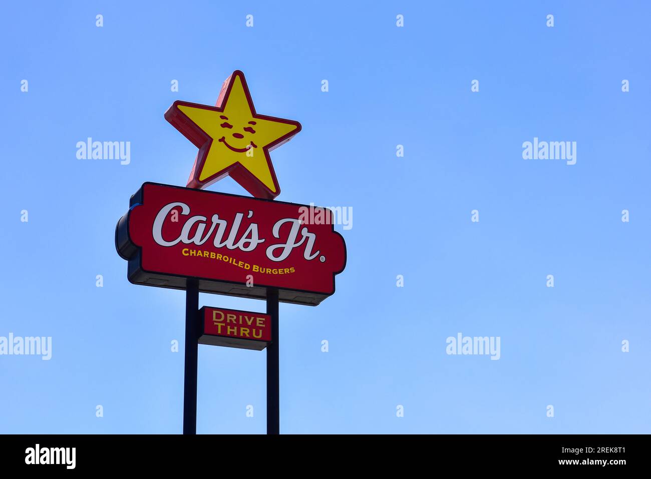 Carls Jr. fast food restaurant sign against bright blue sky Stock Photo ...