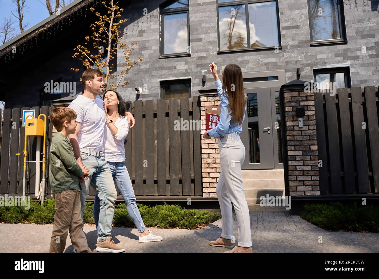 Realtor shows a house to a young family Stock Photo Alamy