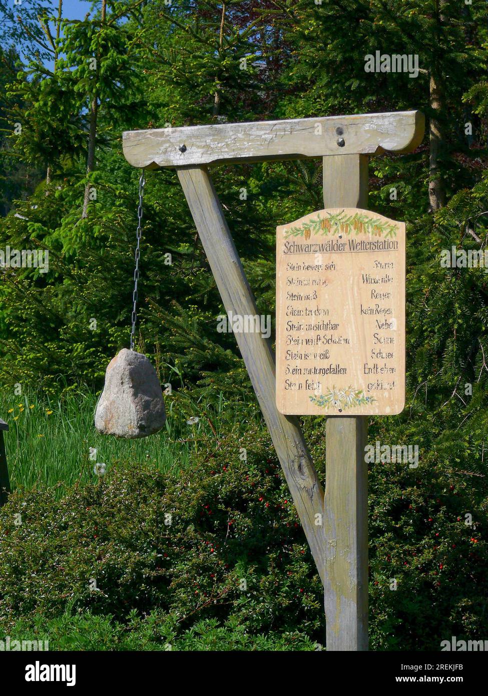 Weather station, funny, simple, witty, in Hinterzarten. Stone hangs on gallows with description board. Black Forest. Bath. -Wuerttemb Stock Photo
