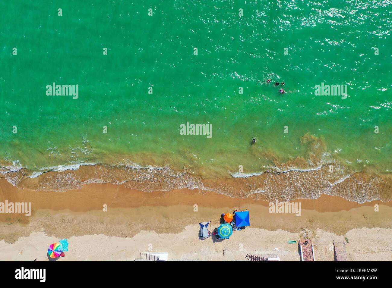 Aerial view of beach umbrellas for the sun Aerial shot, of Bahia de Kino, Sonora Mexico. real
