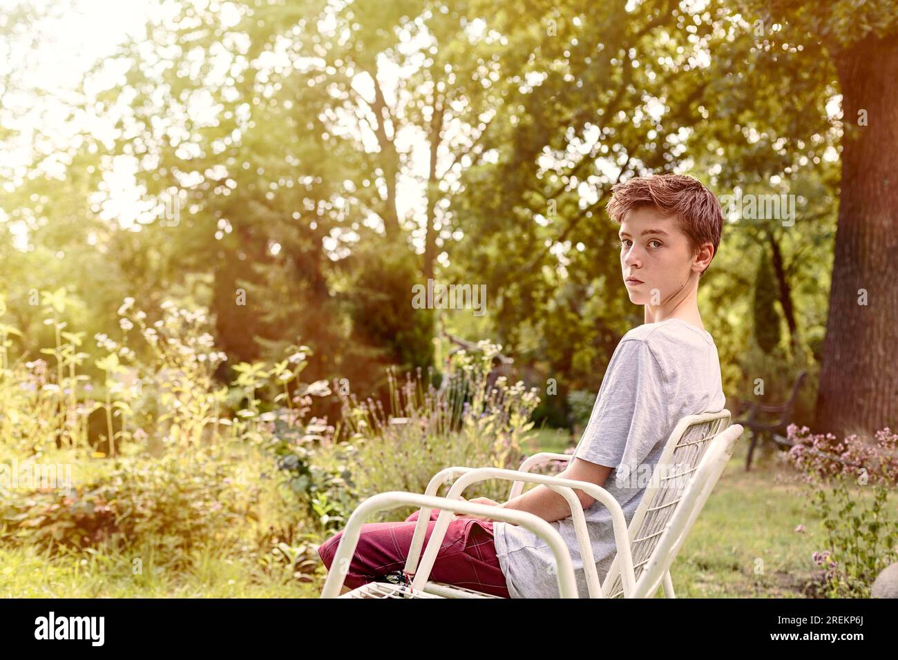 Teenager boy sitting on chair hi-res stock photography and images - Alamy