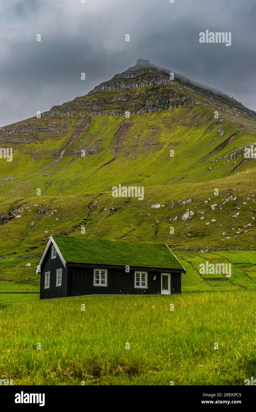Lonely grass roofed house in Gjogv, Estuyroy, Faroe islands, Denmark Stock Photo