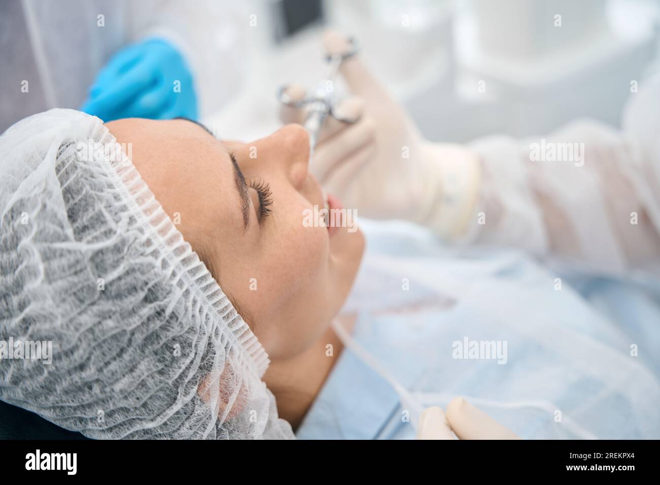 Female patient in dental office receiving an injection of painkiller