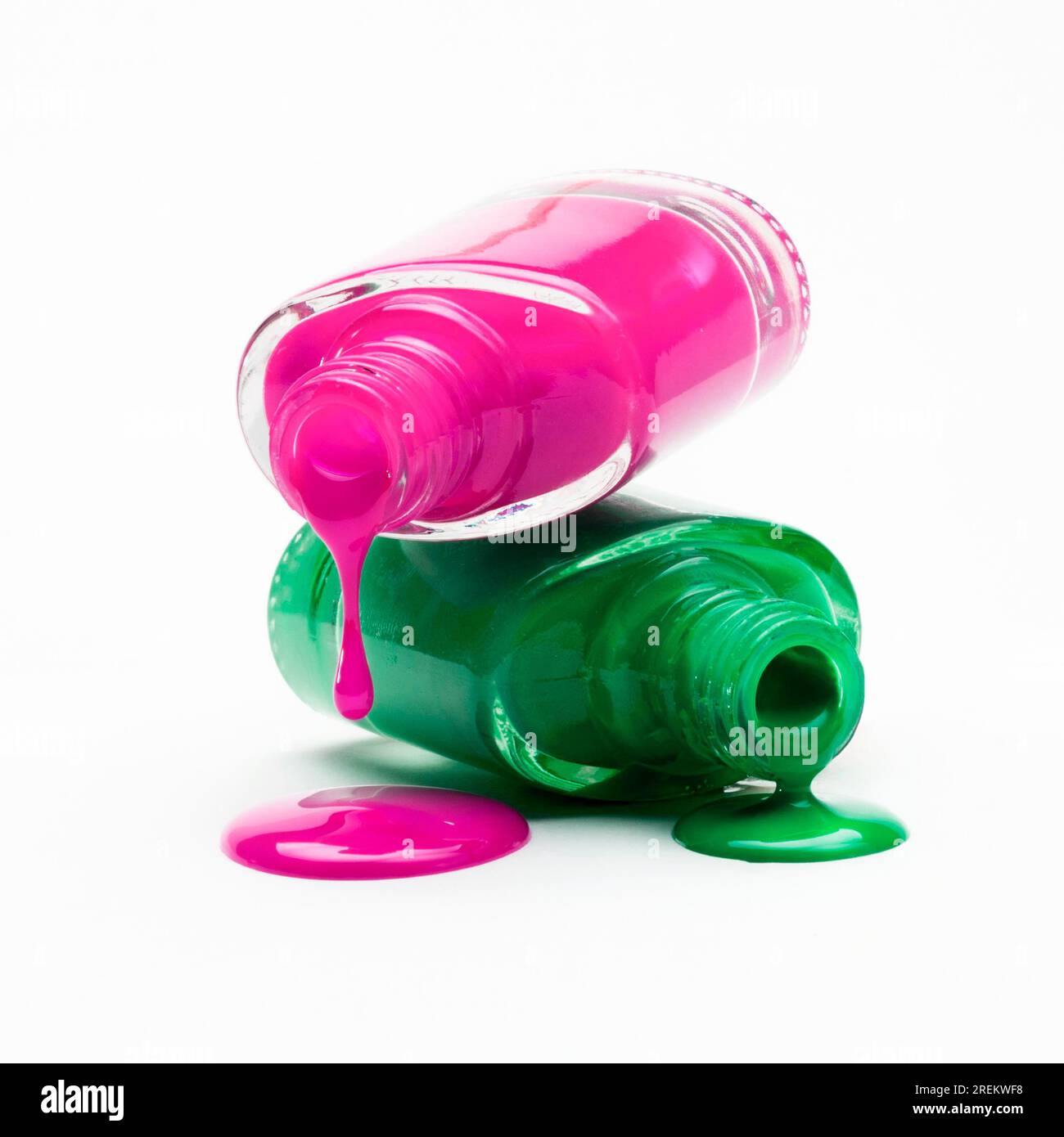 Close up pink green nail polish dripping from bottle. Beautiful photo Stock Photo