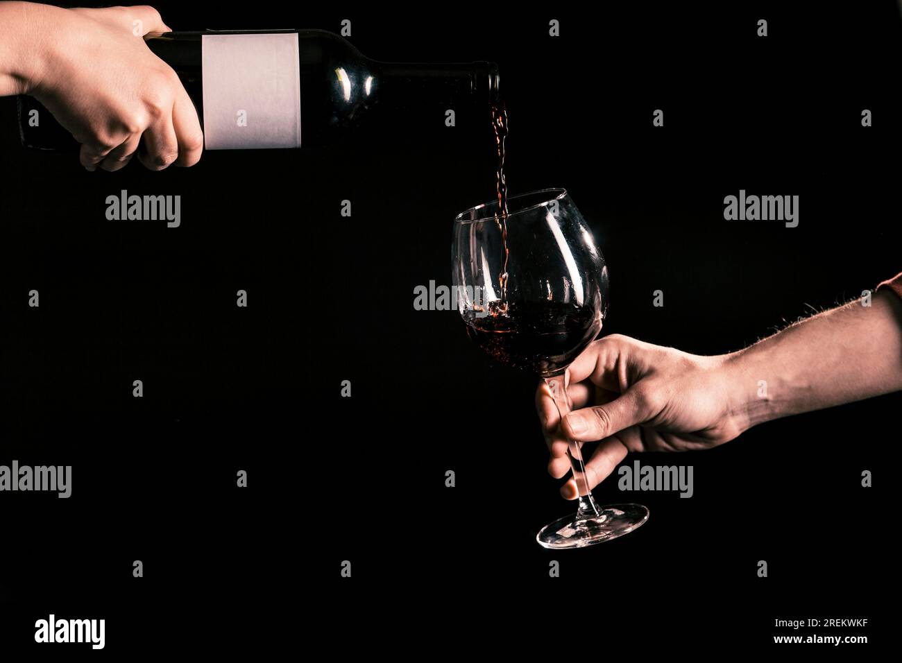 Crop hands pouring wine into glass. Beautiful photo Stock Photo Alamy