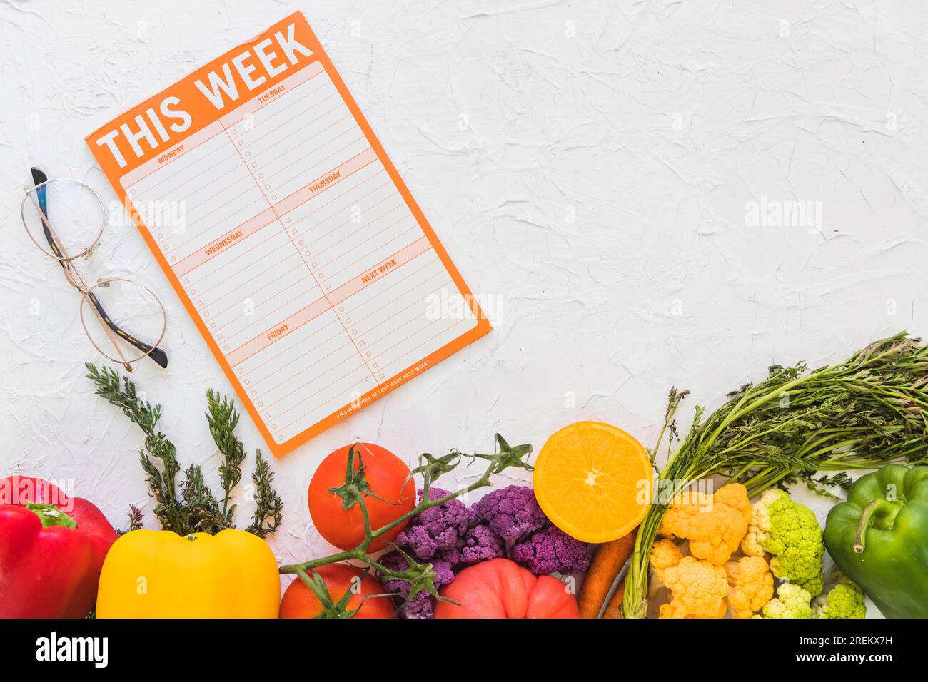 Weekly meal plan with colorful fruits vegetables textured background. Beautiful photo Stock Photo