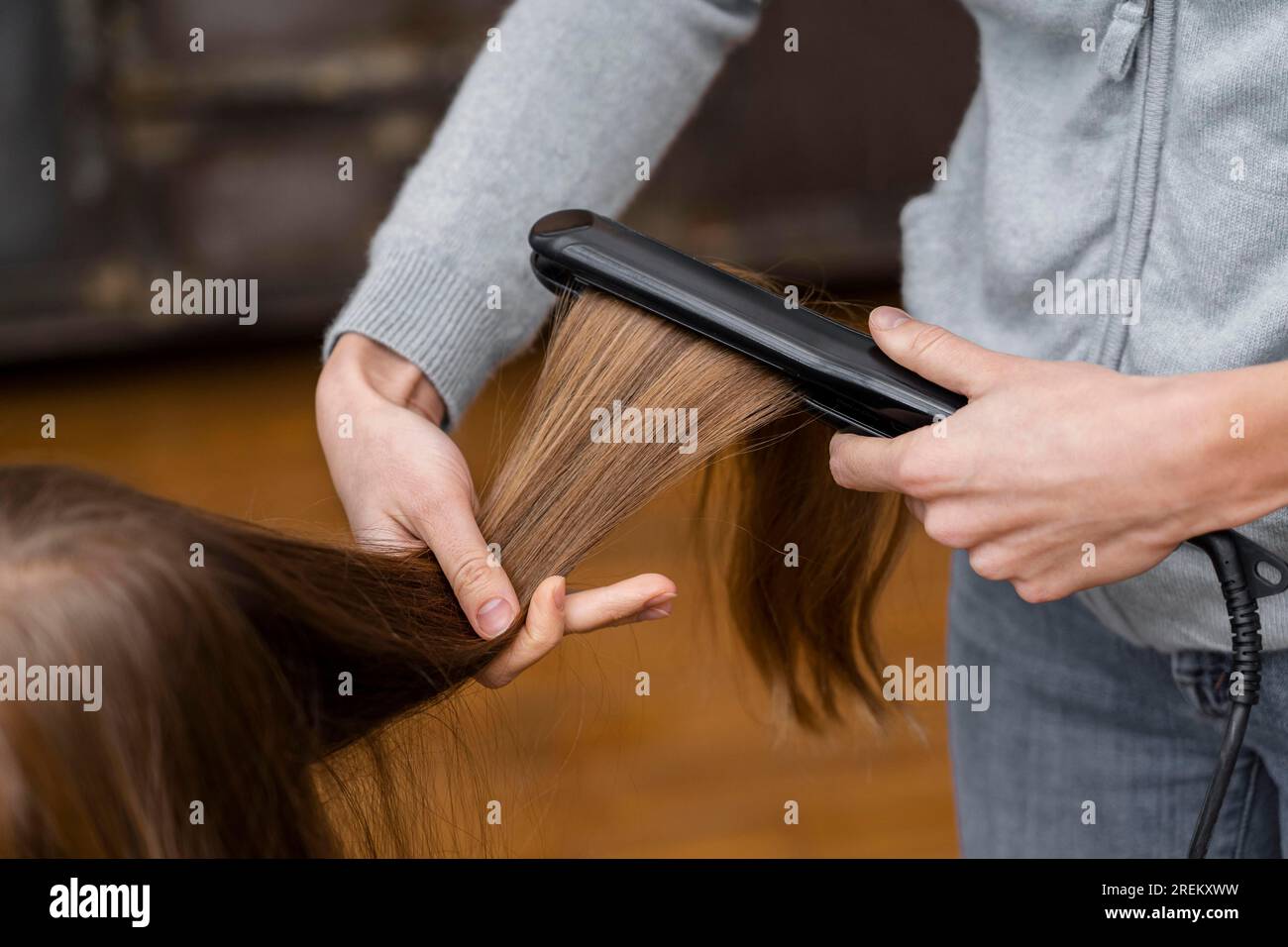 Little girl getting her hair straightened. High resolution photo Stock Photo