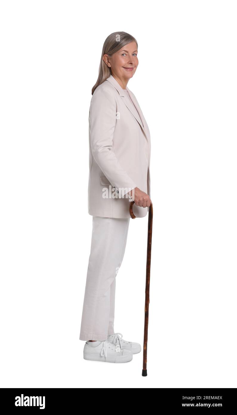 Senior woman with walking cane on white background Stock Photo - Alamy