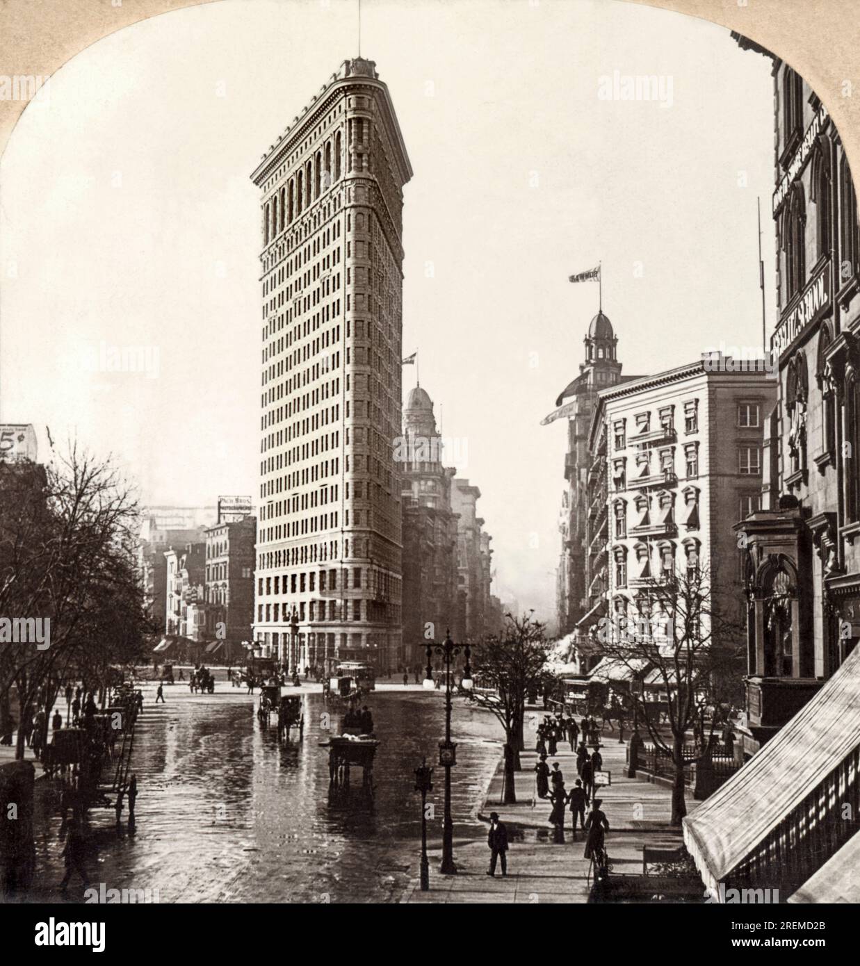 New York, New York:  1903. The Flatiron Building (originally named the Fuller Building) at Fifth Avenue and Broadway at the south end of Madison Square in New York City. It is 22 stories tall and was designed by Daniel Burnham. Stock Photo