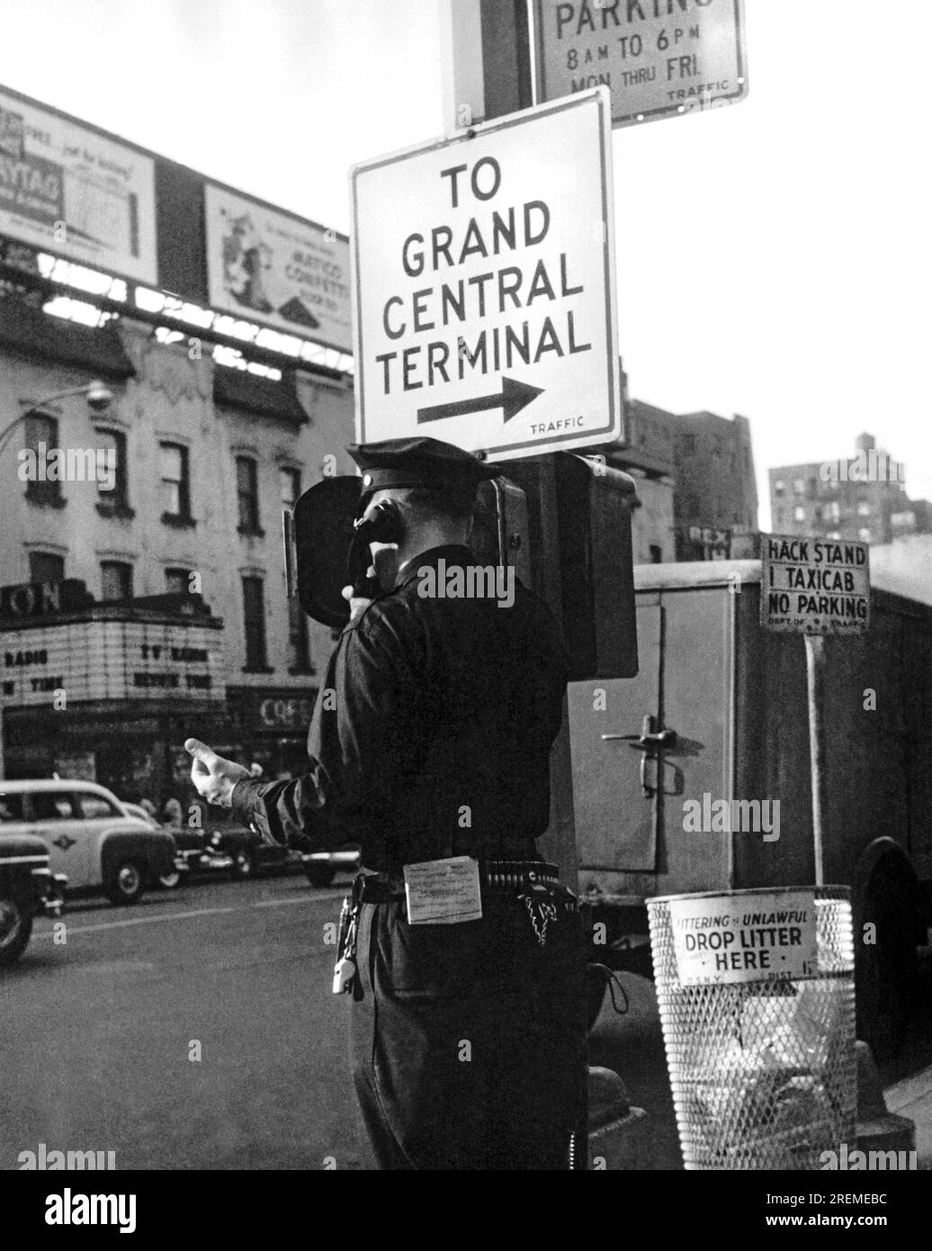 New York, New York:  c. 1946 A policeman next to a Grand Central Terminal sign calls in to headquarters on a police phone. Stock Photo