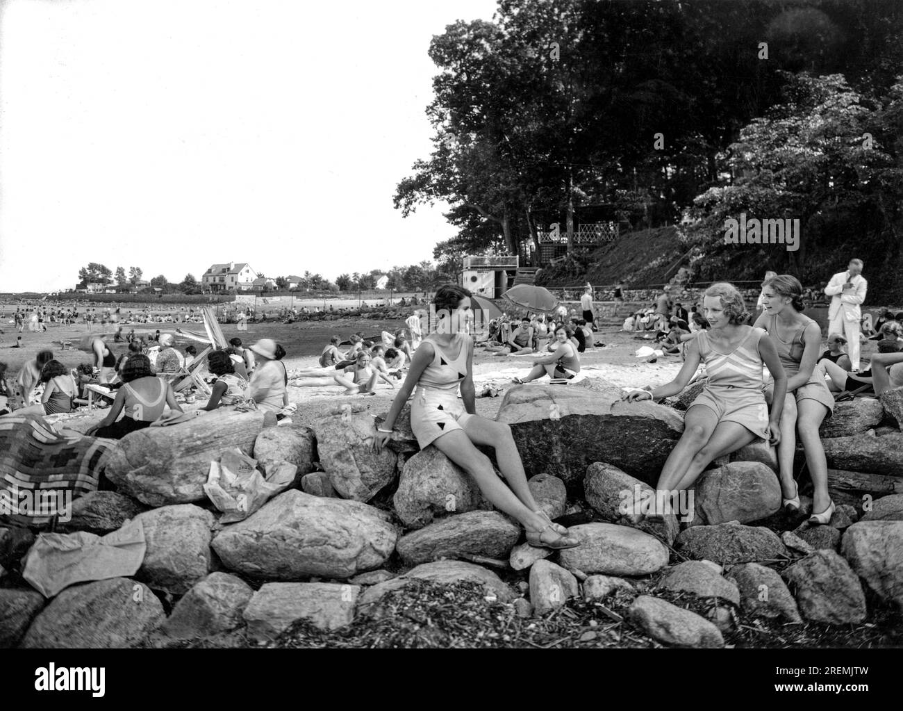 Stamford, Connecticut:  c. 1930 Three women perch on the rocks while enjoying an afternoon at the Shorewood Beach Club. Stock Photo