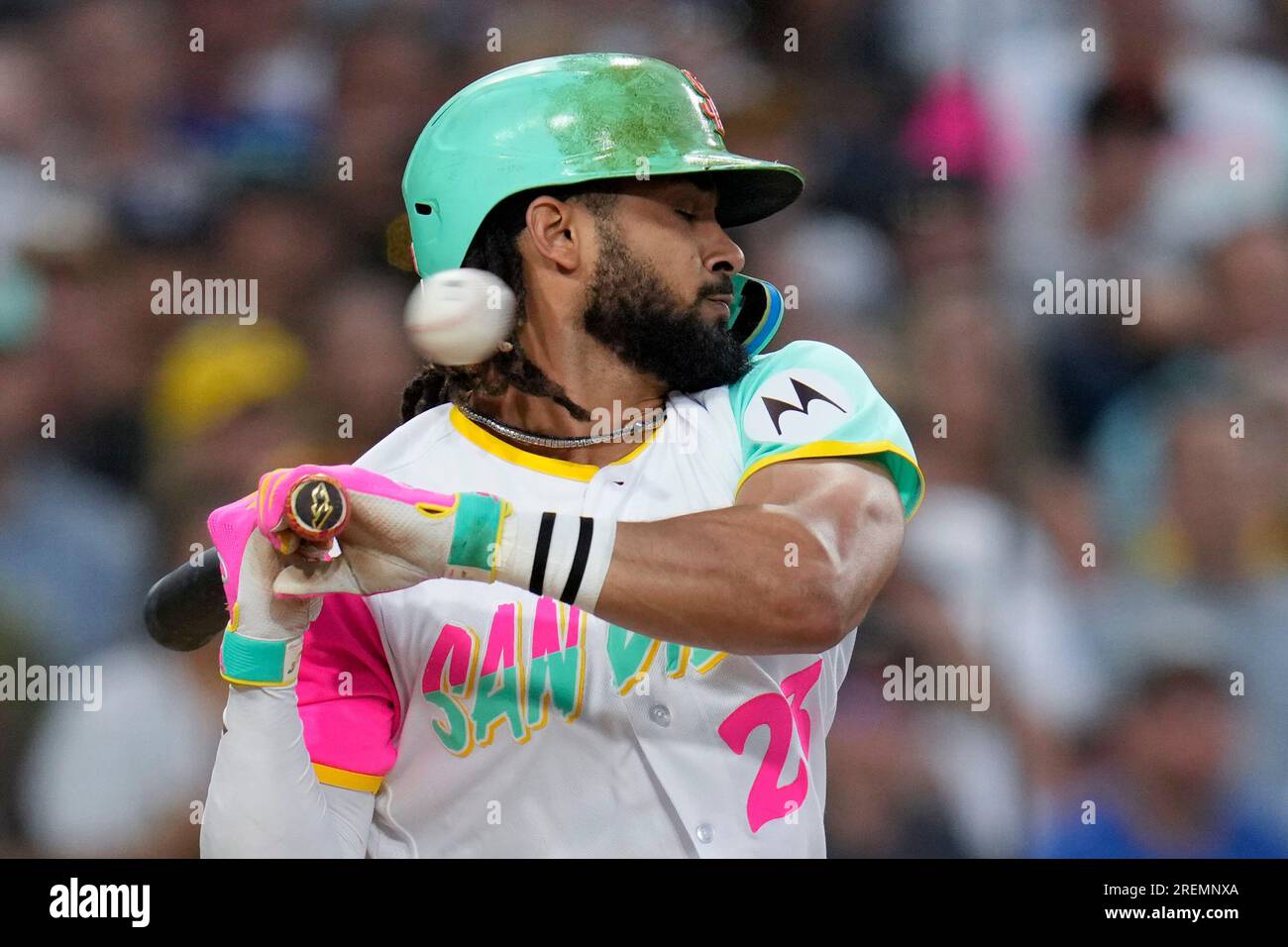 San Diego Padres' Fernando Tatis Jr. moves away from a high and inside