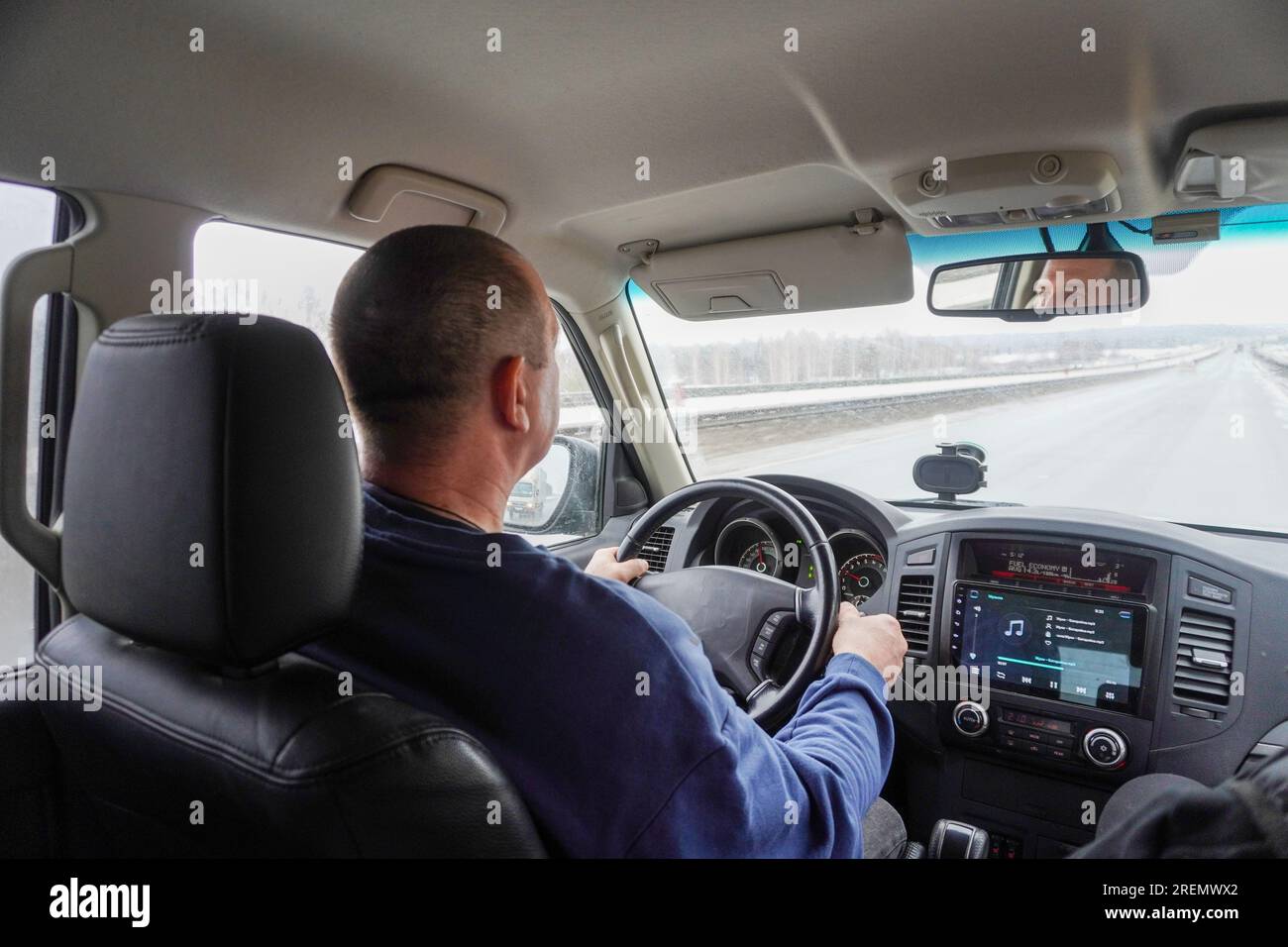 a man is driving a car, rear view, you can see the track in the window ...
