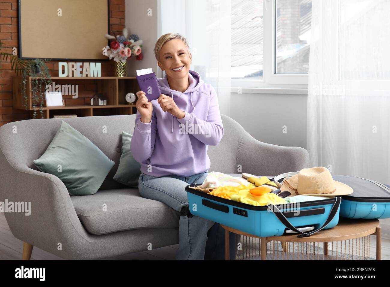 Mature woman passport suitcase hi-res stock photography and images - Alamy