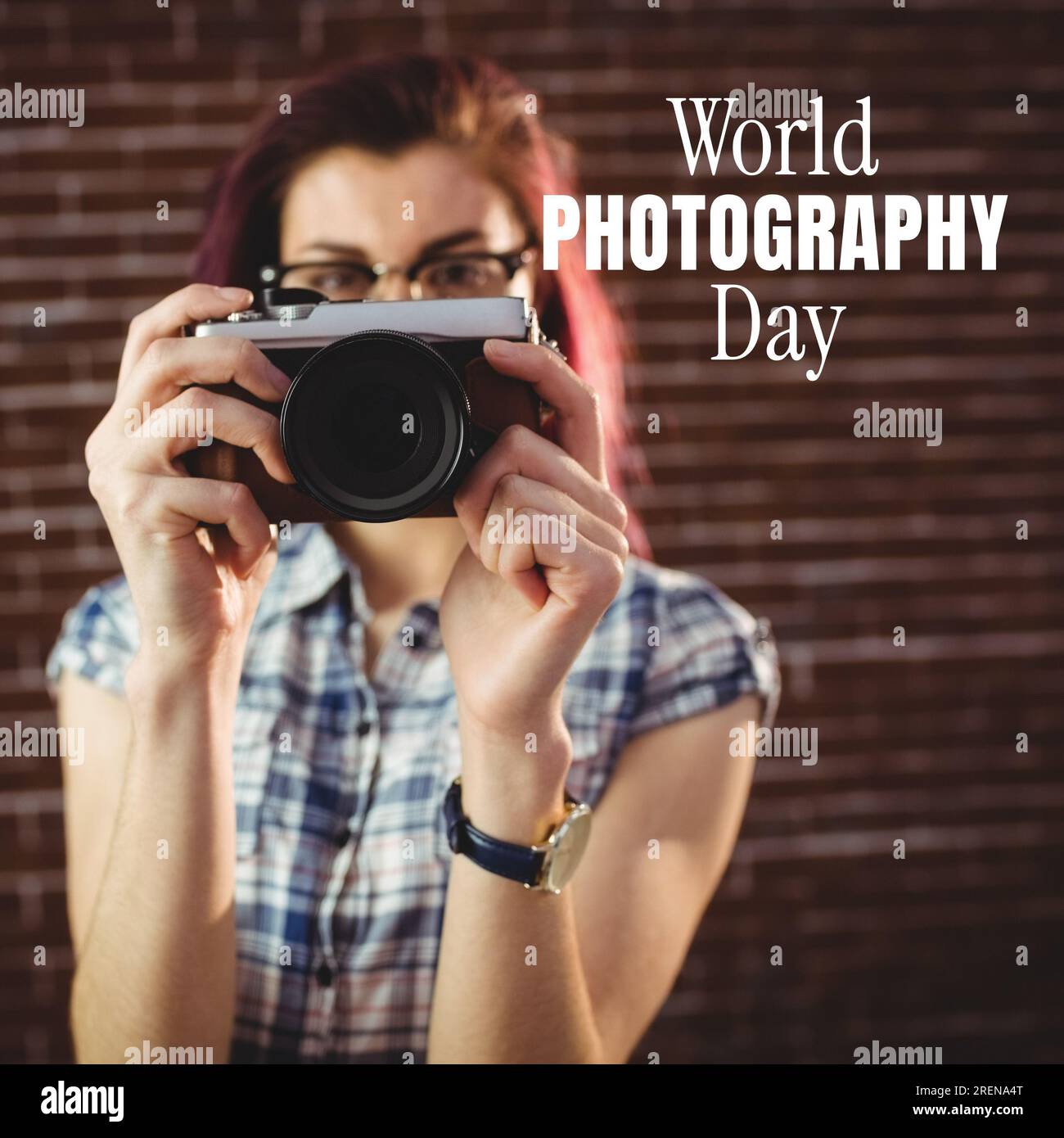 World photography day text in white over caucasian woman in glasses using camera Stock Photo