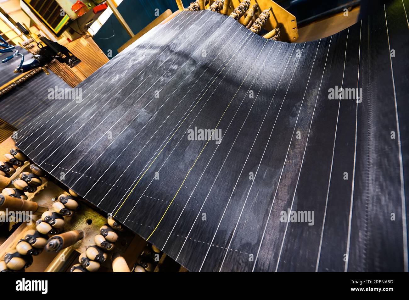 Processing of reinforced rubber cord tape at production line Stock