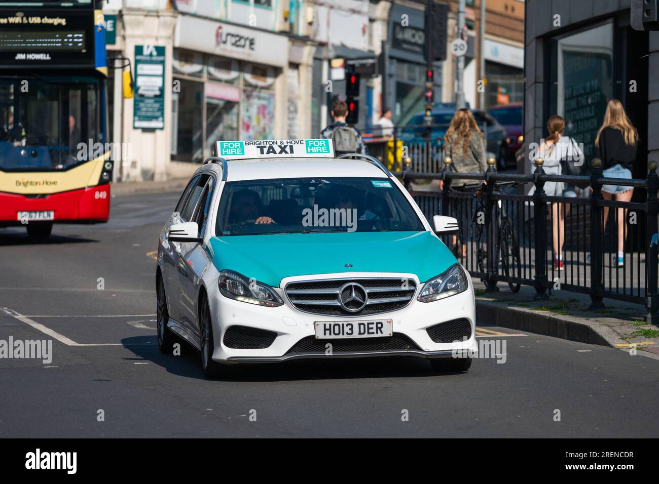 Taxi cab, a Mercedes car, in the busy city of Brighton & Hove, with green and white livery used by many Brighton taxis. In Brighton, England, UK. Stock Photo