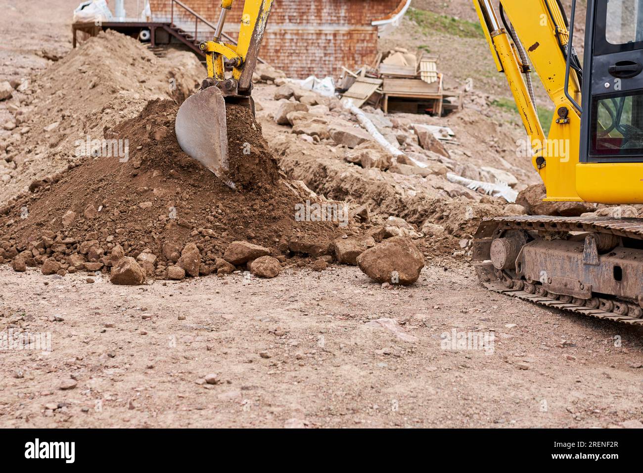 Excavator works in the highlands. Makes a trench for communications ...