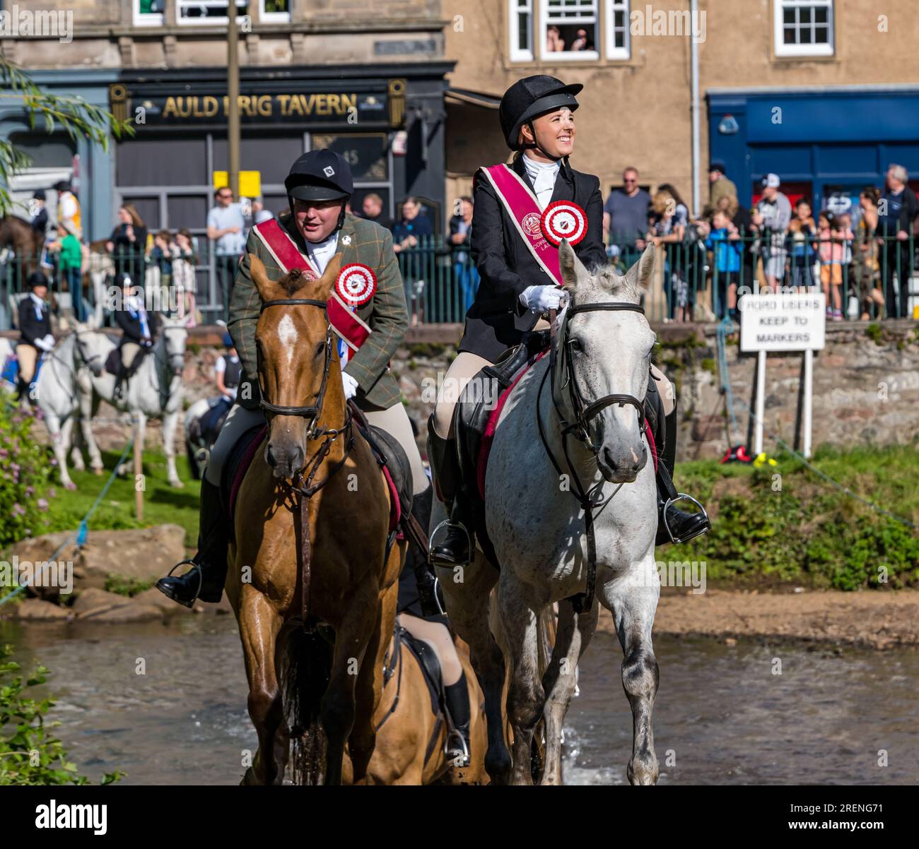 Musselburgh, East Lothian, Scotland, UK,  29th July 2023.. Musselburgh Festival: the week long festival culminates in the Festival Day Rideout with horse riders riding on a route through the town. Pictured: the riders ford the River Esk at the Roman Bridge. Credit: Sally Anderson/Alamy Live News Stock Photo