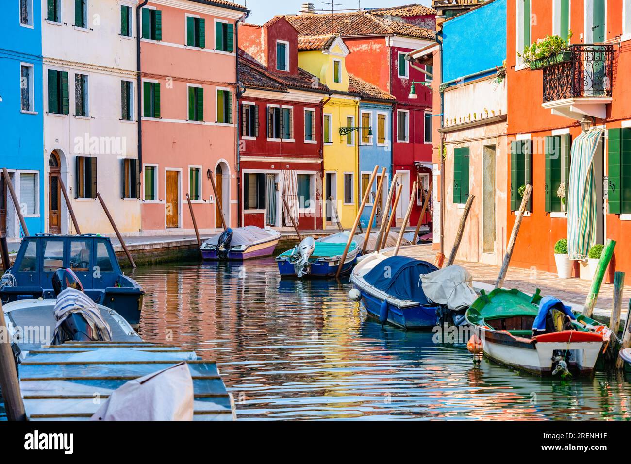 Colorful houses along the water canal in the island of Burano, Venice ...