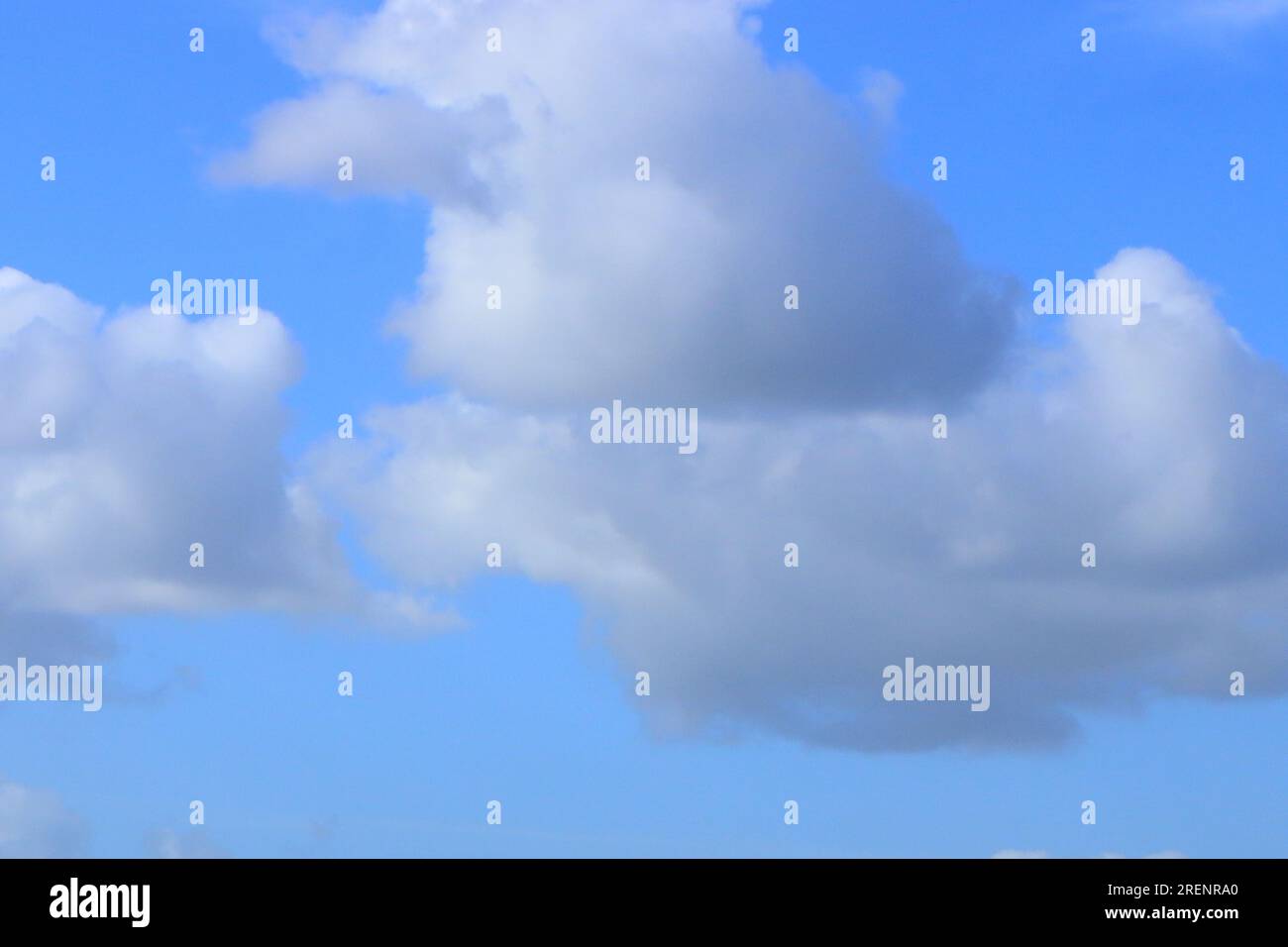 A blue sky background with white and grey cloud formation Stock Photo ...